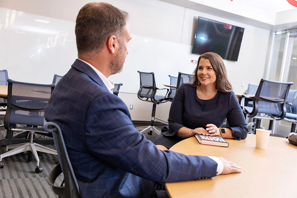 Two people in suits having a conversation